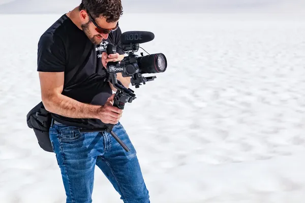 Martin Media cinematographer operating cinema gimbal rig on deep Alaskan glacier snow