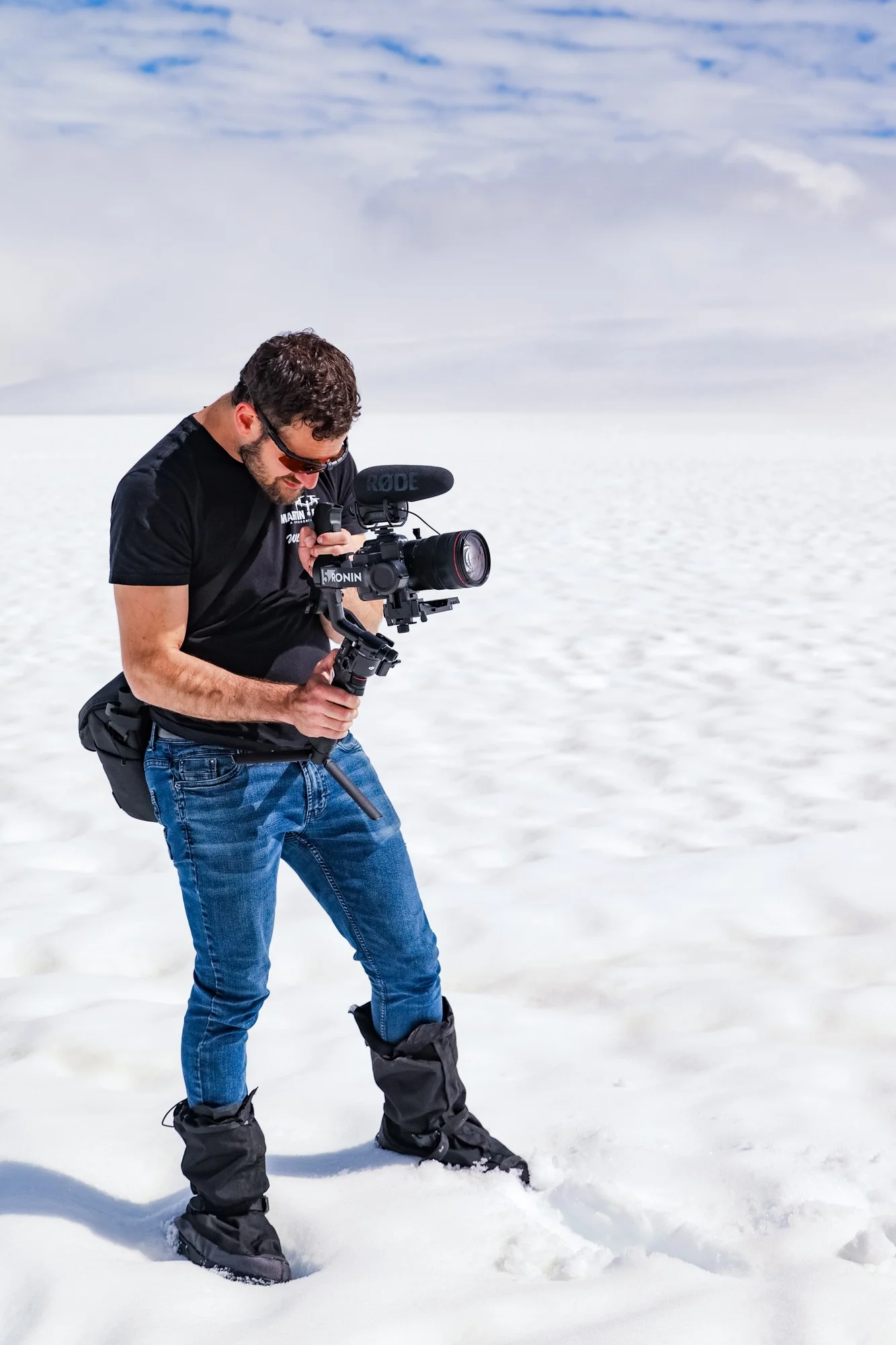 Martin Media cinematographer operating cinema gimbal rig on deep Alaskan glacier snow
