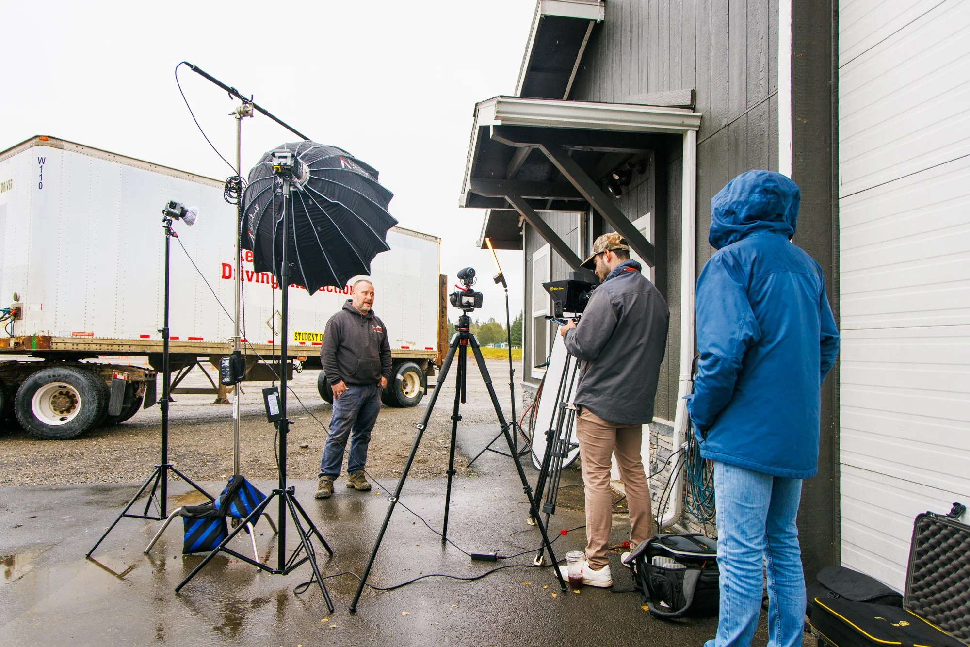 Martin Media outdoor mobile production rig with teleprompter, Aputure softbox, and sound engineer at Kenai Peninsula Driving Instruction